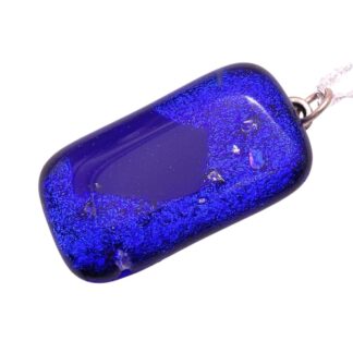 Rectangular blue dichroic glass pendant with a vivid blue hue and textured surface, attached to a silver chain. The pendant's glossy finish conveys elegance.