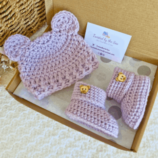 Handmade crochet baby gift set featuring a beanie hat with teddy bear ears and matching booties in a soft Heather purple.