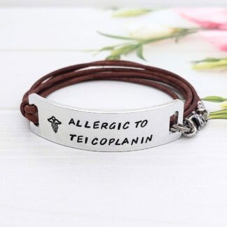 personalised hand stamped medical ID aluminium bar with a leather cord wrap-style bracelet