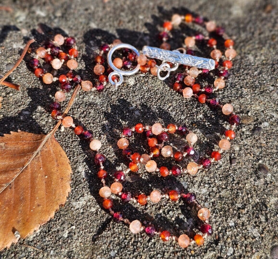 Garnet, sunstone and carnelian gemstone necklace, etched silver toggle, outdoor sun, Isobel Kelly Jewellery