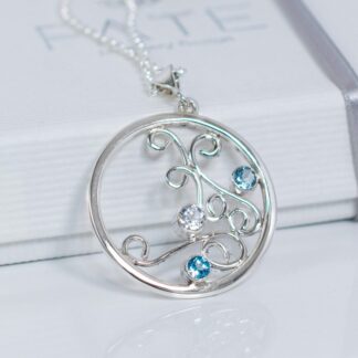 Silver Swirl necklace with Blue Topaz gemstones. Circle shaped on a fine Silver chain