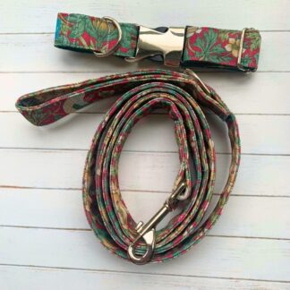 Flat lay photo of dog collar and lead in crimson William Morris Strawberry Thief design