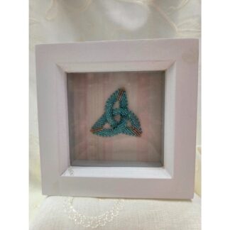 Handmade beaded celtic trefoil in a white shadow box frame