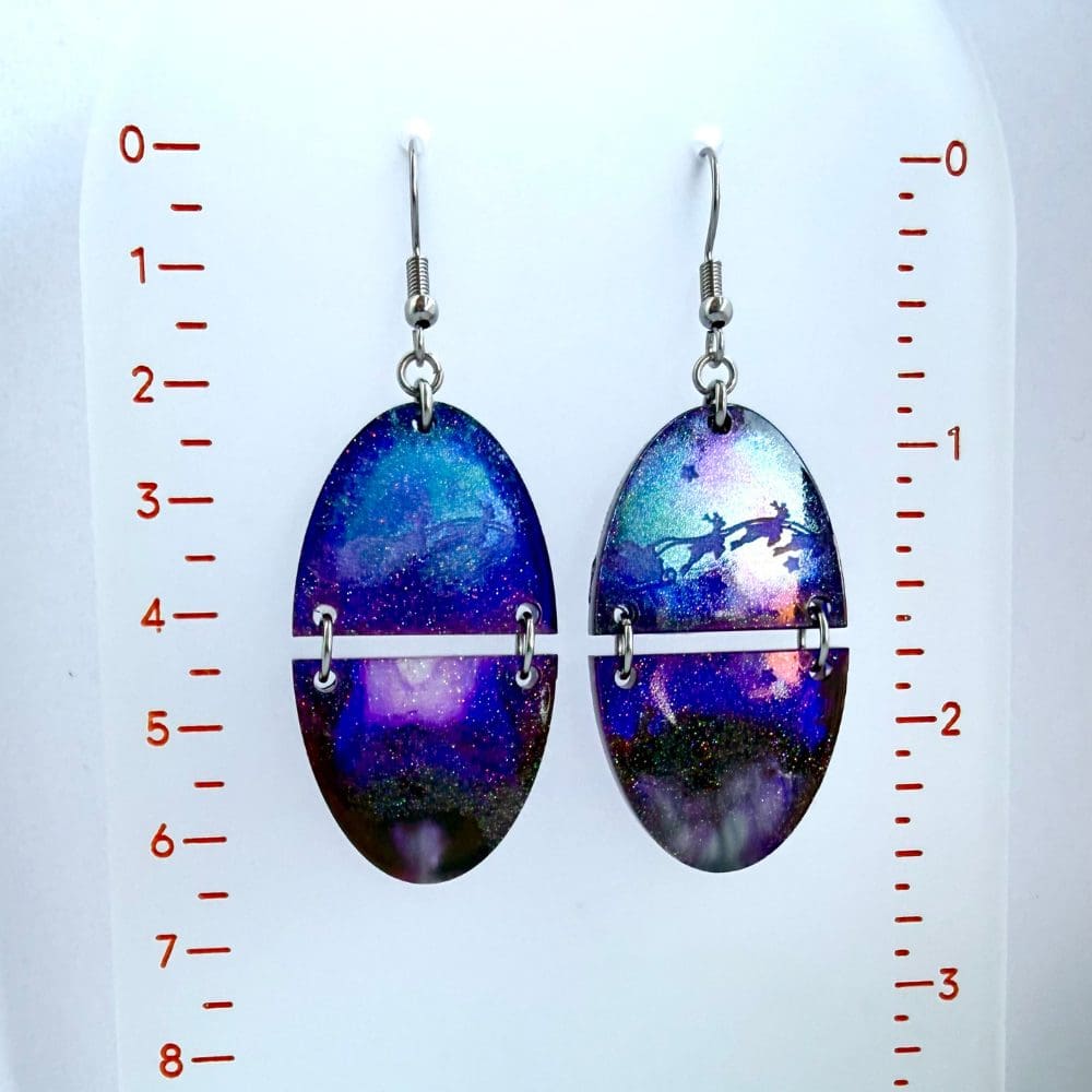 Lightweight festive dangle earrings featuring aurora background and Santa sleigh silhouette