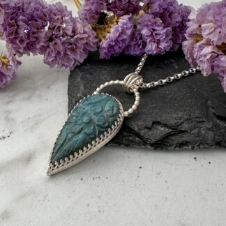 Handmade silver necklace with teardrop blue labradorite carved with a floral design.