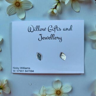 Silver tear shaped studs surrounded by petals