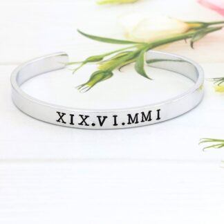 6mm aluminium cuff hand-stamped with a personalised date in roman numerals