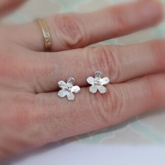 Textured silver flower stud earrings