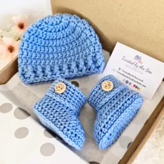 Handmade crochet baby beanie hat and matching booties set in nigella blue with 'How Cute Are You' wooden buttons.