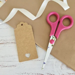 Optional gift wrapping for handmade baby gifts, finished with kraft paper, ribbon and gift tag
