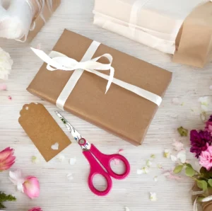 Optional gift wrapping for handmade baby gifts, finished with kraft paper, ribbon and gift tag