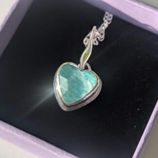 Handcrafted sterling silver heart pendant with an Amazonite and rose-cut quartz doublet, set in a fine silver bezel on a polished backplate. A delicate silver leaf sits above the heart, finished with a sterling chain. The pendant rests inside a lavender gift box with a soft black interior