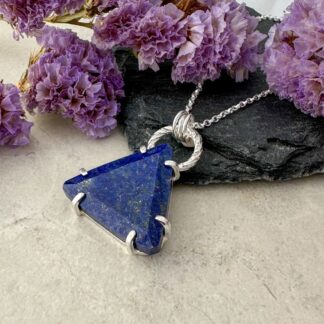 Handmade sterling silver necklace with a deep blue lapis lazuli gemstone in a claw setting.