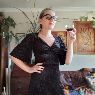 black velvet dress with gold glitter, flared sleeve and diamond shaped neckline