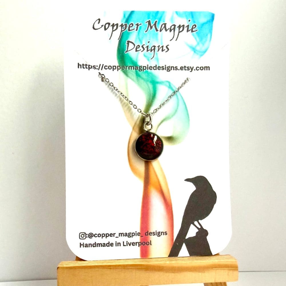 10 mm cabuchon necklace with crimson molten effect on a branded Copper Magpie Designs Card