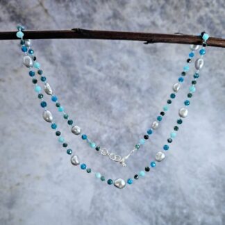 Grey baroque pearl, blue tourmaline, apatite and amazonite, hanging grey background, Isobel Kelly Jewellery