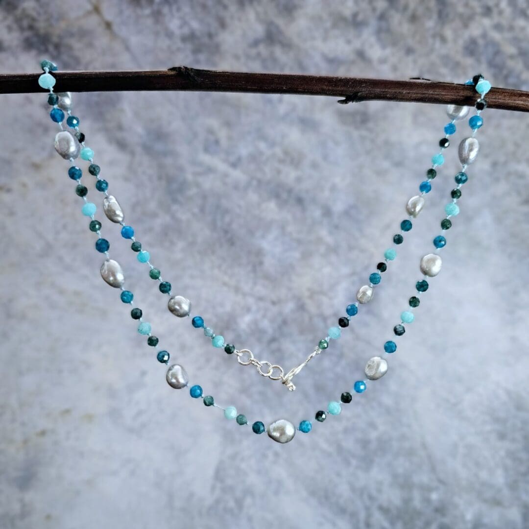 Grey baroque pearl, blue tourmaline, apatite and amazonite, hanging grey background, Isobel Kelly Jewellery