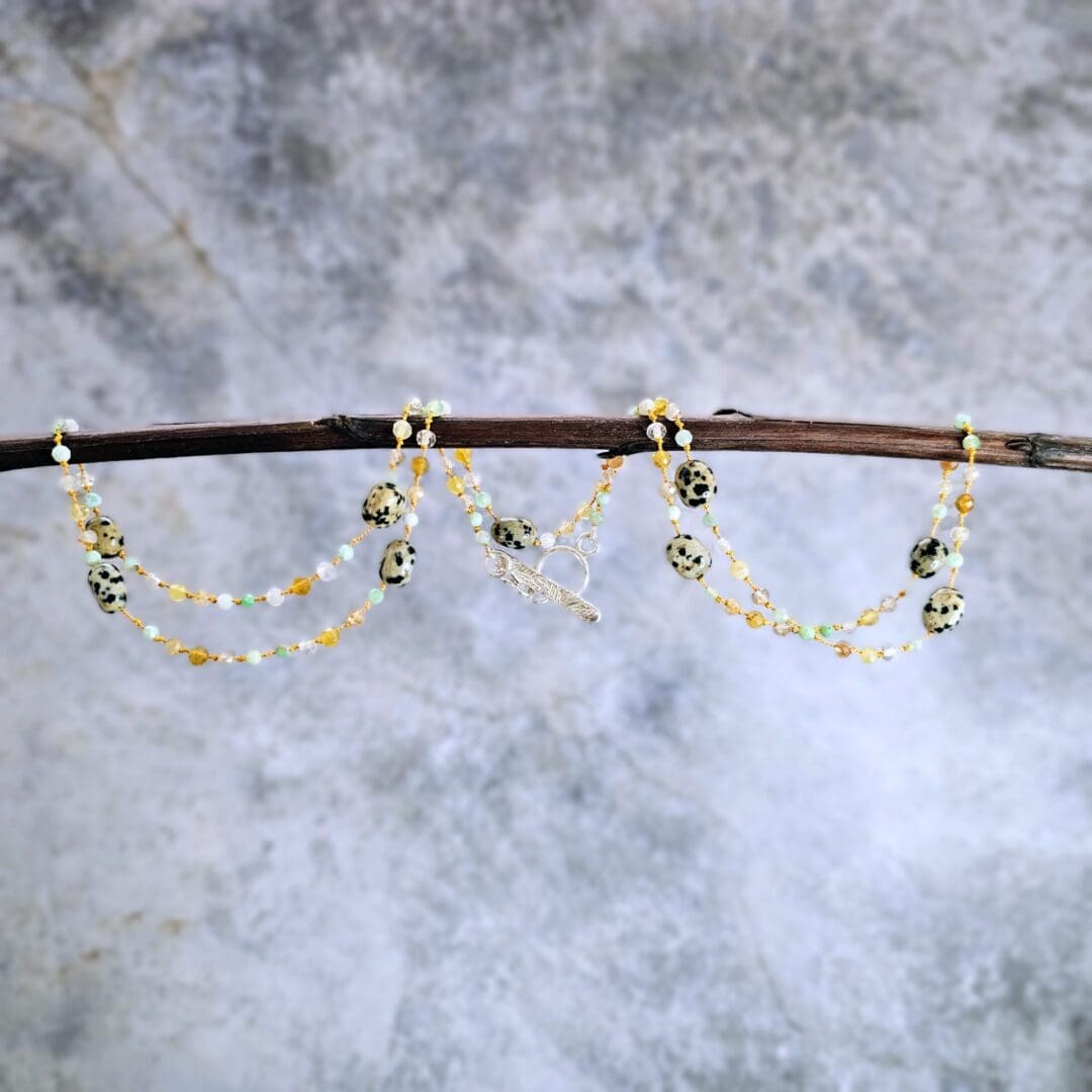 Chrysoprase, yellow opal, rutilated quartz, Dalmatian jasper knotted strand, silver toggle, grey background hanging, Isobel Kelly Jewellery