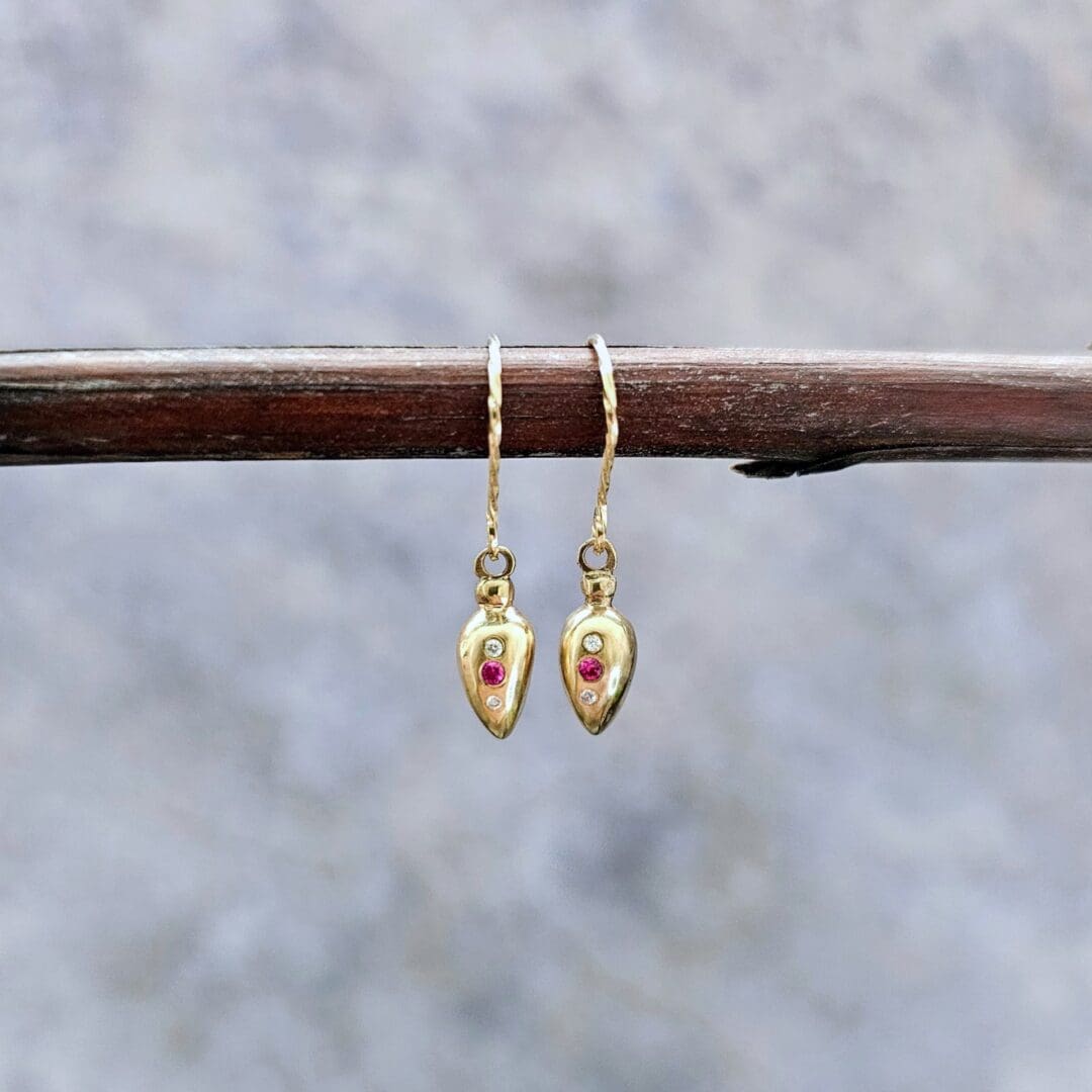 9ct gold drop earrings inspired by Roman amphora vessels, set with lab-grown diamonds and a central pink ruby, featuring twisted gold hooks. Front, hanging. Isobel Kelly Jewellery, Hants UK