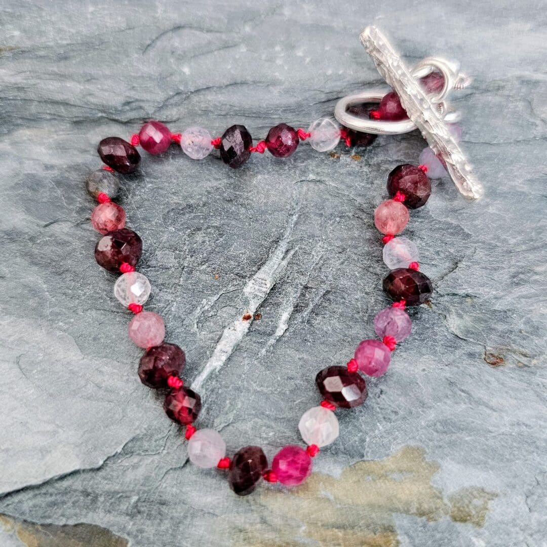 Spinel and garnet gemstone bracelet, grey background, Isobel Kelly Jewellery