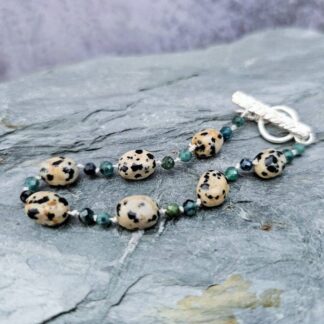 Blue tourmaline & Dalmatian jasper gemstone bracelet, grey background, Isobel Kelly Jewellery