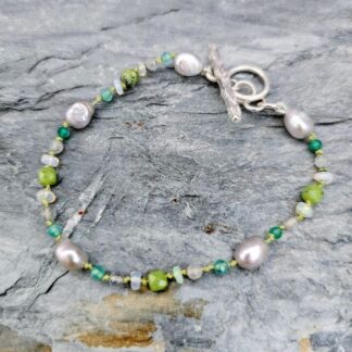 Grey baroque pearl, agate, jade, labradorite and Ethiopian opal gemstone bracelet, grey background, Isobel Kelly Jewellery