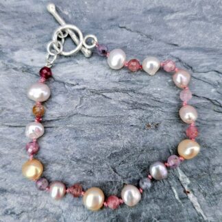Rose gold baroque pearl, ruby and sapphire gemstone bead bracelet, grey background, Isobel Kelly Jewellery