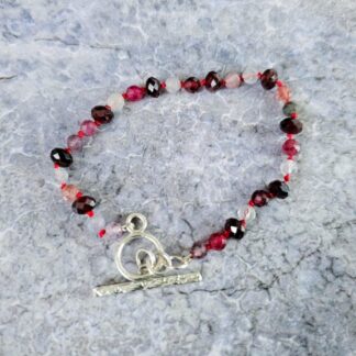 Spinel and garnet gemstone bracelet, grey background top, Isobel Kelly Jewellery