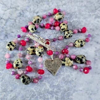Ruby, pink tourmaline, Dalmatian jasper and pink jade gemstone necklace, with etched silver folk heart and toggle, grey background full, Isobel Kelly Jewellery