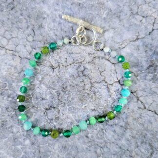Gemstone bracelet with chrysoprase, green agate, jade and amazonite beads, silver toggle, grey background, Isobel Kelly Jewellery