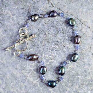 Tanzanite, labradorite, peacock pearl bracelet, grey background shot, Isobel Kelly Jewellery