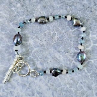 Aquamarine, morganite and peacock baroque pearl bracelet, grey background, Isobel Kelly Jewellery