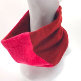 Model wearing terracotta and cerise neck warmer
