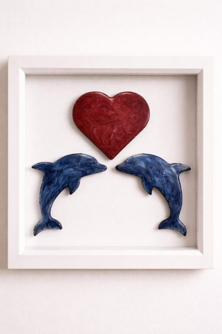 Handcrafted resin wall art of two seahorses beneath a red heart in a matt white box frame.