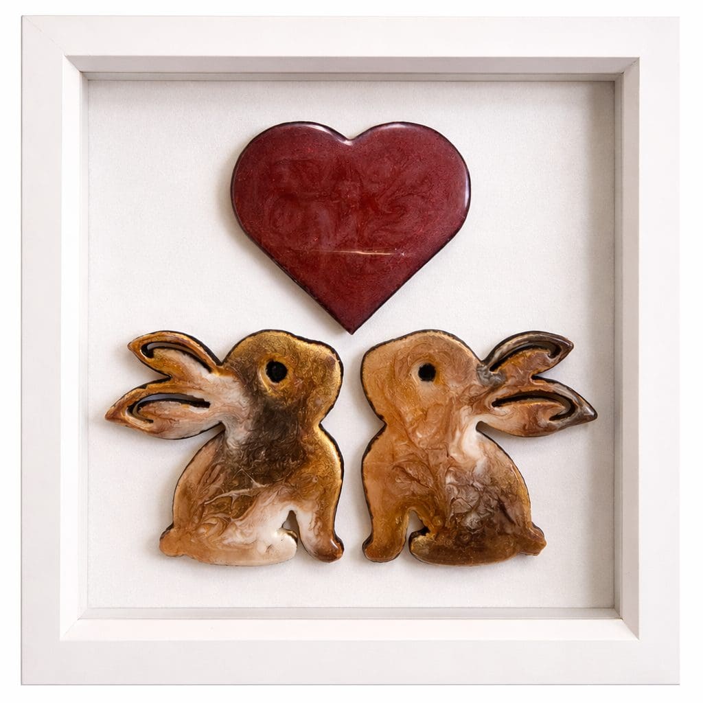Framed resin rabbit artwork with two rabbits beneath a red heart.