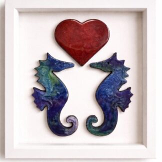 Handcrafted resin wall art of two seahorses beneath a red heart in a matt white box frame.