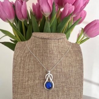 Unusual sparkly deep green dichroic glass on a silver plated celtic knot pendant