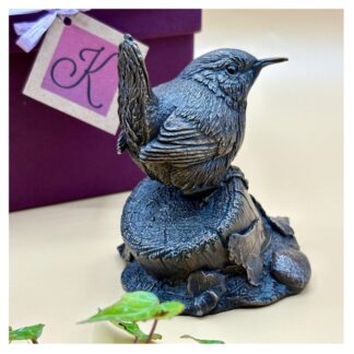 Foundry bronze Wren sculpture showing the finely sculpted bird perched on a small post with Ivy at its base. Sculpted by Kirsty Armstrong in the UK.