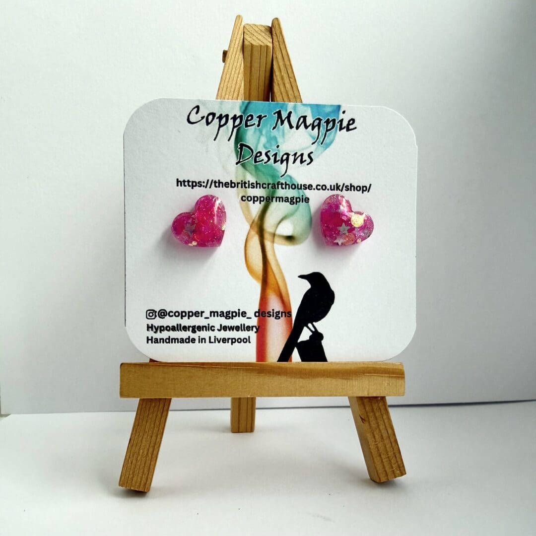 Pink Glitter love heart earrings displayed on a branded Copper Magpie Designs card.