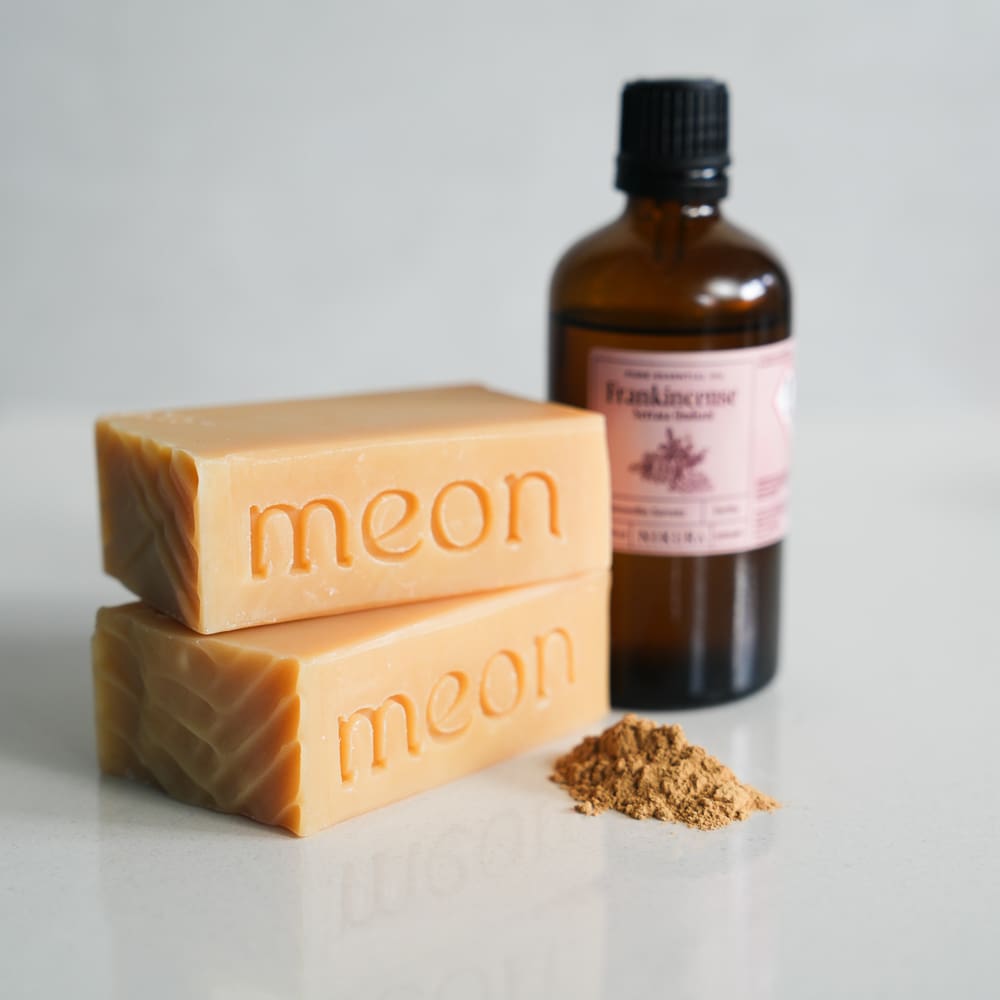 Yellow soap bar with french yellow clay and essential oil bottle