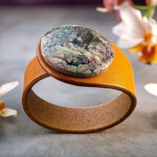 Natural Scenic Moss Agate Leather Bracelet = eaturing a tiny landscape in stone – with soft greens, mauves, and earthy tones forming natural, moss-like patterns that feel alive under the surface. Handcrafted by Freak Like Me in Bristol