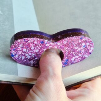 Pink glitter resin page holder for one handed reading