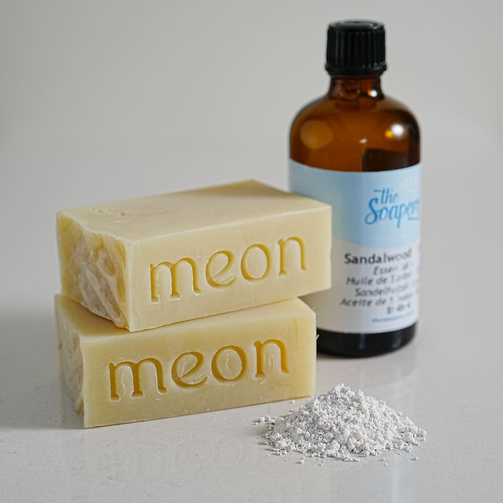 White soap bars with french white clay and essential oil bottle