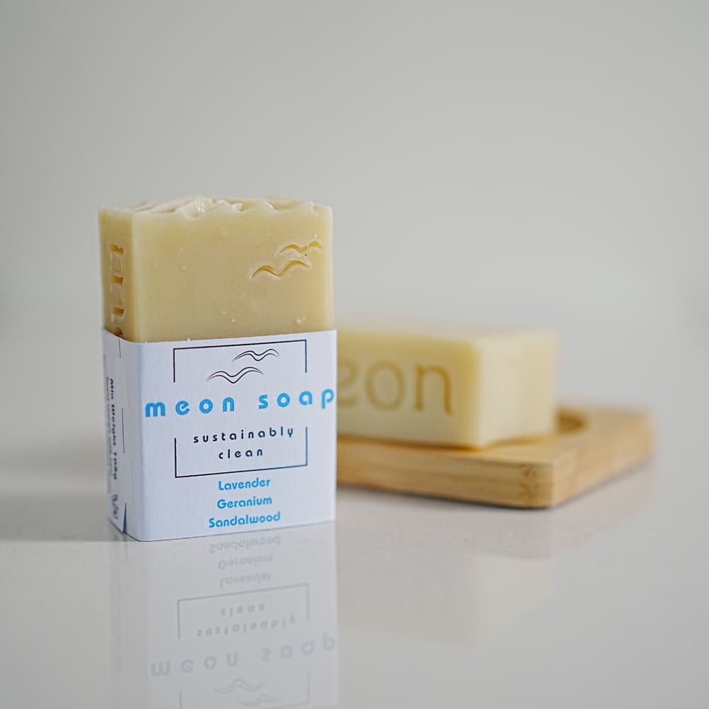 White soap bar in wooden soap dish