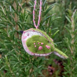 A handmade-felt-and-fabric-bird-decoration. Bright-green-felt-and-a-delicate-pink-folral-fabric.