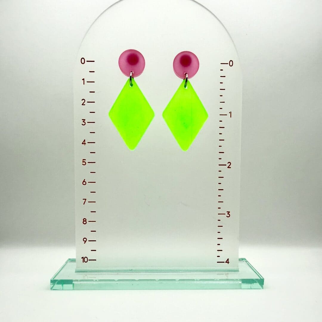 Handmade glow in the dark statement earrings with holographic resin finish on a earring hanger displaying the drop length of 44 mm (approx)