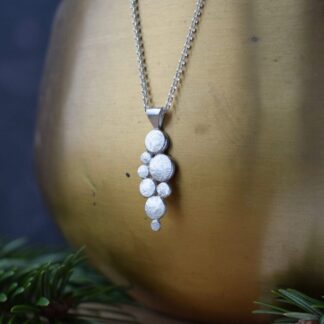 sterling silver drop pendant handmade with textured silver pebbles to reflect the seashore