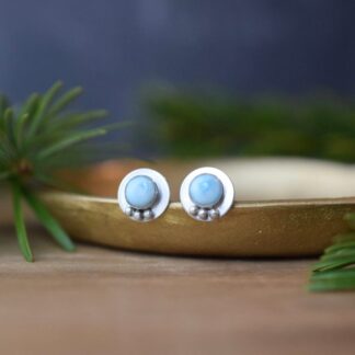 round sterling silver stud earrings with blue larimar stones