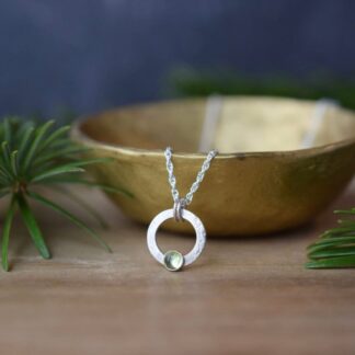 small open circle textured silver necklace with green peridot birthstone
