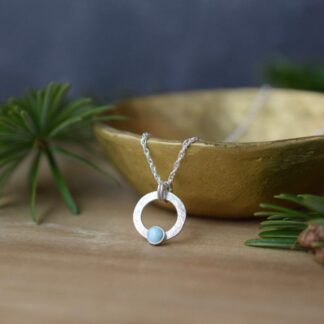 small silver circle necklace with larimar stone